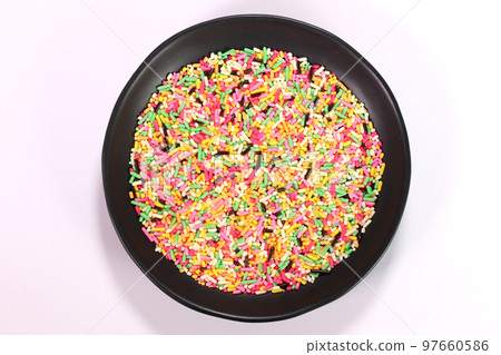 Colorful chocolate spray served on a plate Colorful chocolate spray served on a plate 97660586