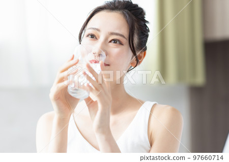 A woman drinking water A woman drinking water 97660714