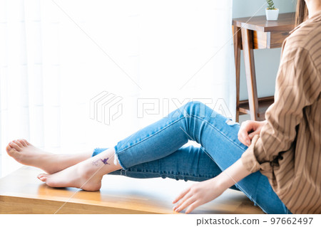 A woman with a tattoo on her ankle [parts cut] 97662497