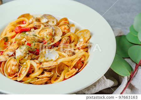 Spicy delicious Chinese authentic food Clam Mara stir-fried noodles dish in white bowl 97663163