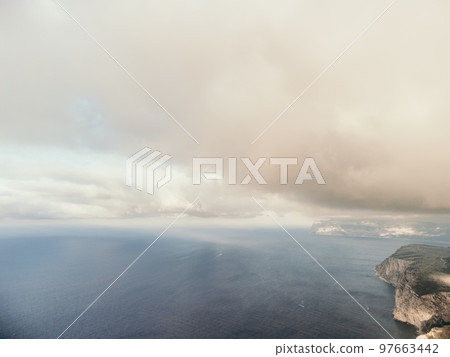 Aerial view. The drone flies over foggy and fluffy clouds. Blue sky sun and sea fog. Abstract aerial nature summer ocean sunset sea and sky background. Horizon. Vacation, travel and holiday concept Aerial view. The drone flies over foggy and fluffy clouds. Blue sky sun and sea fog. Abstract aerial nature summer ocean sunset sea and sky background. Horizon. Vacation, travel and holiday concept 97663442