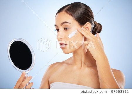 Mirror, face or woman with skincare cream for beauty or sunscreen protection in grooming morning routine in studio. Wellness, dermatology or girl model applying facial lotion or cosmetics product Mirror, face or woman with skincare cream for beauty or sunscreen protection in grooming morning routine in studio. Wellness, dermatology or girl model applying facial lotion or cosmetics product 97663511