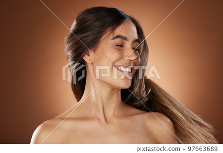 Hair, beauty and skincare with a model woman in studio on a brown background for natural or keratin treatment. Face, haircare and salon with an attractive young female posing to promote a product 97663689