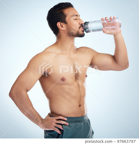Fitness, health or man drinking water in studio after training in workout or exercise for body goals or wellness. Motivation, weight loss or tired healthy person relaxing and drinks liquid or bottle Fitness, health or man drinking water in studio after training in workout or exercise for body goals or wellness. Motivation, weight loss or tired healthy person relaxing and drinks liquid or bottle 97663787