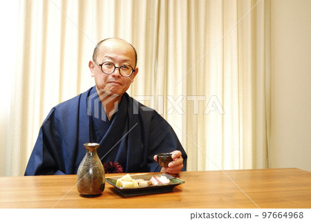 A man who enjoys drinking in a kimono A man who enjoys drinking in a kimono 97664968