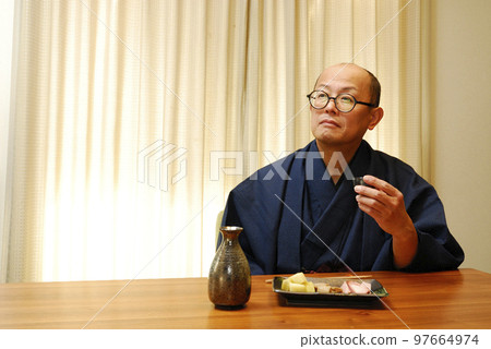 A man who enjoys drinking in a kimono A man who enjoys drinking in a kimono 97664974