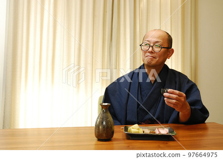 A man who enjoys drinking in a kimono A man who enjoys drinking in a kimono 97664975