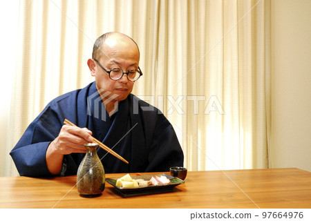 A man who enjoys drinking in a kimono A man who enjoys drinking in a kimono 97664976