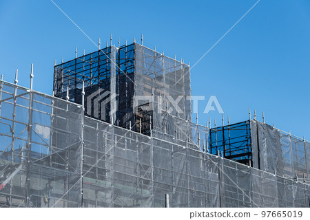 Blue sky and large-scale repair work on an apartment building Blue sky and large-scale repair work on an apartment building 97665019