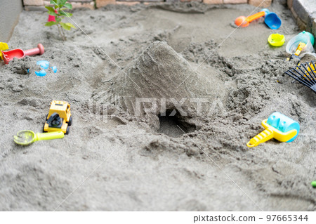 A mountain with a tunnel made by playing in the sandbox 97665344
