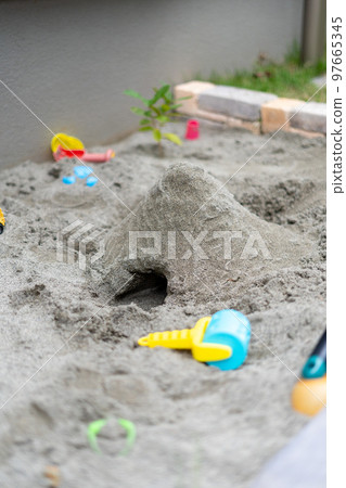 A mountain with a tunnel made by playing in the sandbox 97665345