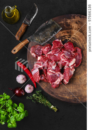 Top view of chopping fresh beef meat on wooden chopping stump 97666186