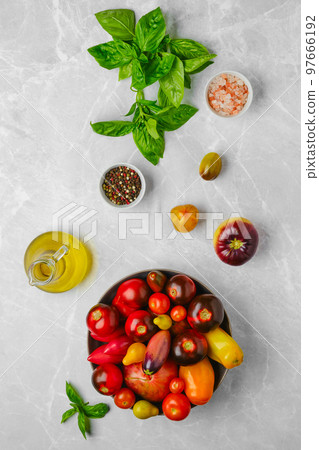 Vertical composition with assortment of tomatoes, basil and spice 97666192