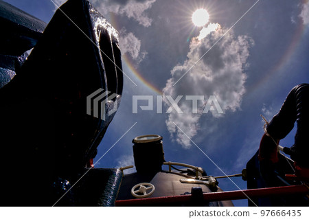 A wheel of fortune and a steam locomotive (Mikado) appearing in the sky 97666435