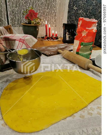 Saffron bun on kitchen background Saffron bun on kitchen background 97666997