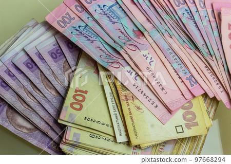 Paper money different denominations, Ukrainian hryvnia in denominations 50,100, 200 hryvnias, new money, background with scattered banknotes Paper money different denominations, Ukrainian hryvnia in denominations 50,100, 200 hryvnias, new money, background with scattered banknotes 97668294