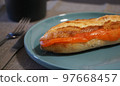 A stylish breakfast of French bread sandwiched with smoked salmon 97668457