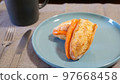 A stylish breakfast of French bread sandwiched with smoked salmon 97668458
