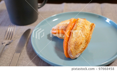 A stylish breakfast of French bread sandwiched with smoked salmon 97668458