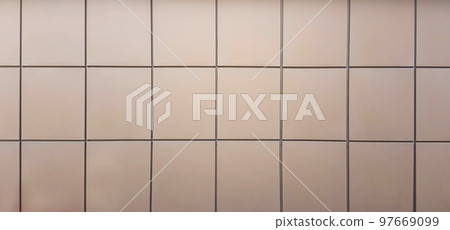light facing tiles on the wall of a city building 97669099