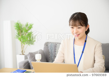 A woman working while humidifying A woman working while humidifying 97669369
