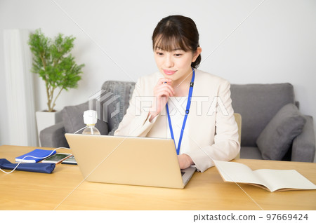 A woman working while humidifying A woman working while humidifying 97669424