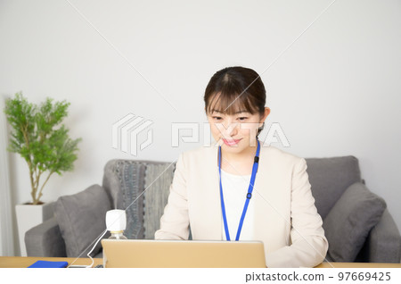 A woman working while humidifying A woman working while humidifying 97669425