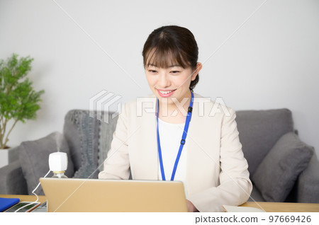 A woman working while humidifying A woman working while humidifying 97669426
