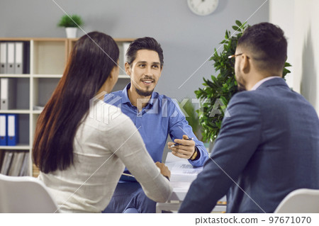 Happy family couple signing contract together in office Happy family couple signing contract together in office 97671070