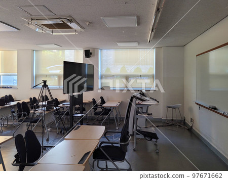 An empty lecture hall with afternoon sunlight shining through 97671662