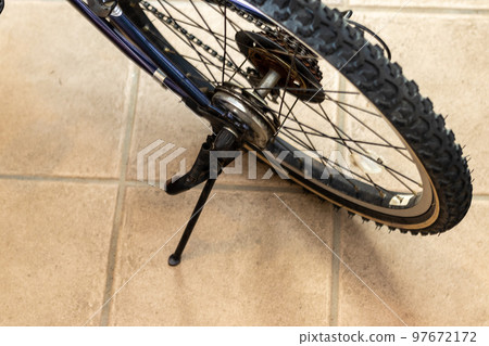 A bicycle wheel supported by a stand 97672172