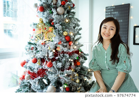 Woman decorating a Christmas tree. 97674774