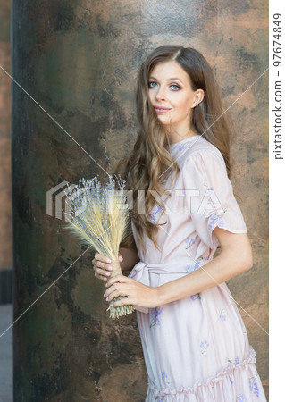 Beautiful brunette with lavender flowers. A woman with healthy clean skin and a bouquet of dried flowers. Perfume fragrance concept. High quality photo Beautiful brunette with lavender flowers. A woman with healthy clean skin and a bouquet of dried flowers. Perfume fragrance concept. High quality photo 97674849