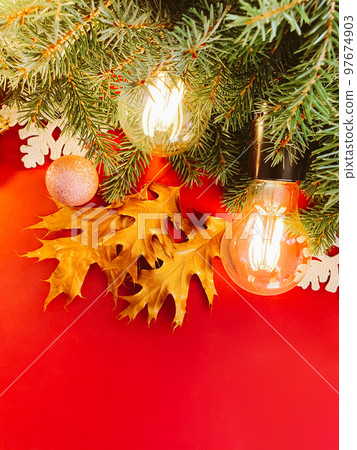 Christmas background, fir tree, balls, Golden brown oak leaves and magic retro lights on red background. Copy space, Cosmetic product advertising backdrop. Empty place to display product package 97674903