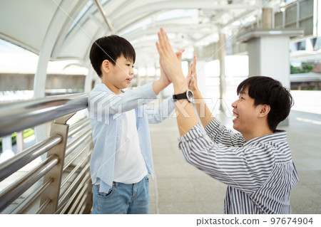 Man embracing his son. Man embracing his son. 97674904