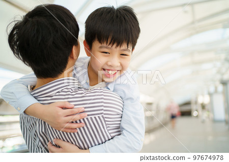 Man embracing his son. 97674978