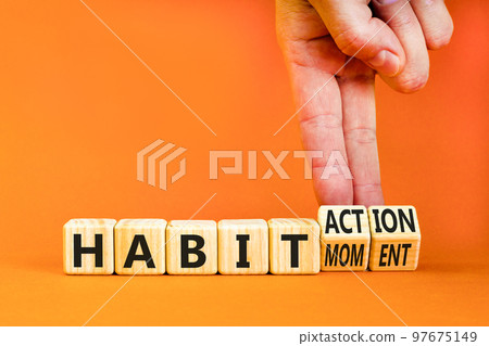 Habit action and moment symbol. Concept words Habit action Habit moment on wooden cubes. Businessman hand. Beautiful orange table orange background. Business habit action moment concept. Copy space. 97675149