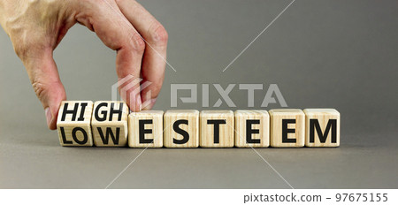High or low esteem symbol. Concept words High esteem and Low esteem on wooden cubes. Businessman hand. Beautiful grey table grey background. Business high or low esteem concept. Copy space. High or low esteem symbol. Concept words High esteem and Low esteem on wooden cubes. Businessman hand. Beautiful grey table grey background. Business high or low esteem concept. Copy space. 97675155