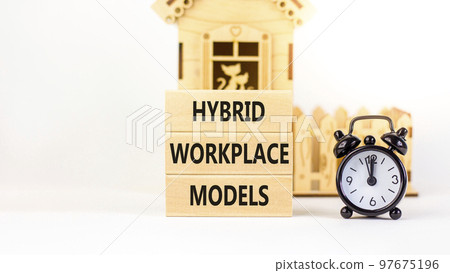 Hybrid workplace models symbol. Concept words Hybrid workplace models on wooden blocks. Black alarm clock. Beautiful white table white background. Business hybrid workplace models quote concept. Copy Hybrid workplace models symbol. Concept words Hybrid workplace models on wooden blocks. Black alarm clock. Beautiful white table white background. Business hybrid workplace models quote concept. Copy 97675196