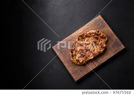 Delicious juicy grilled pork steak with spices and herbs Delicious juicy grilled pork steak with spices and herbs 97675568