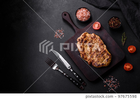 Delicious juicy grilled pork steak with spices and herbs 97675598