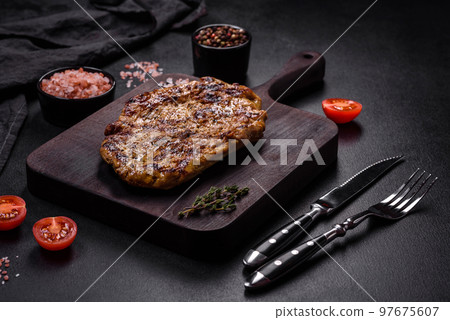 Delicious juicy grilled pork steak with spices and herbs 97675607