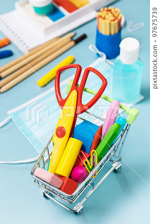 School supplies, poppit anti-stress, face mask, bottle of sanitizer, for back to school on a blue background. Covid-19 precautions, staying healthy. School supplies, poppit anti-stress, face mask, bottle of sanitizer, for back to school on a blue background. Covid-19 precautions, staying healthy. 97675739