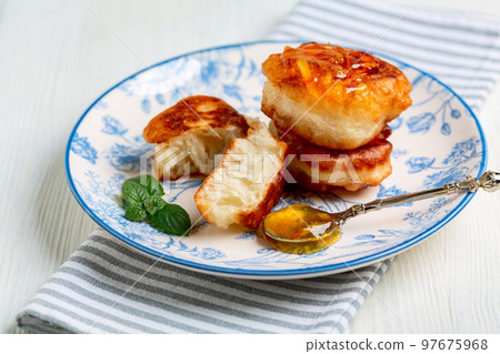 Homemade fritters (pancakes) with jam. 97675968