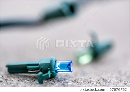 Focus on replacement bulb for a string of Christmas lights to repair a dud.  97676762