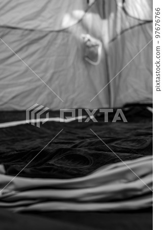 Selective focus of an inflatable air mattress on the floor of a tent being filled up. Selective focus of an inflatable air mattress on the floor of a tent being filled up. 97676766