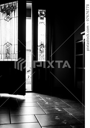 Track of small child footprints visible on a tile floor with an open door letting in light in the background Track of small child footprints visible on a tile floor with an open door letting in light in the background 97676778