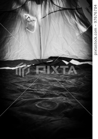 Selective focus of an inflatable air mattress on the floor of a tent being filled up. Selective focus of an inflatable air mattress on the floor of a tent being filled up. 97676784