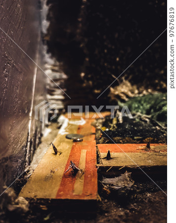 Carpet tack strip exposed during a flooring home improvement project 97676819