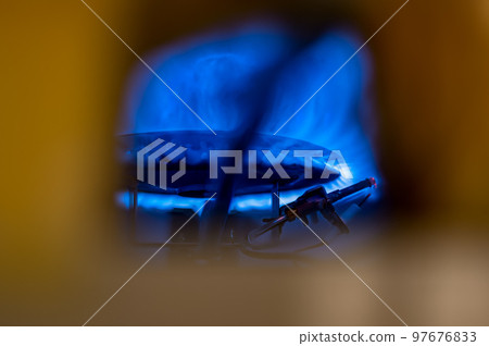 Pilot light auto igniter inside a hot water heater with flames Pilot light auto igniter inside a hot water heater with flames 97676833